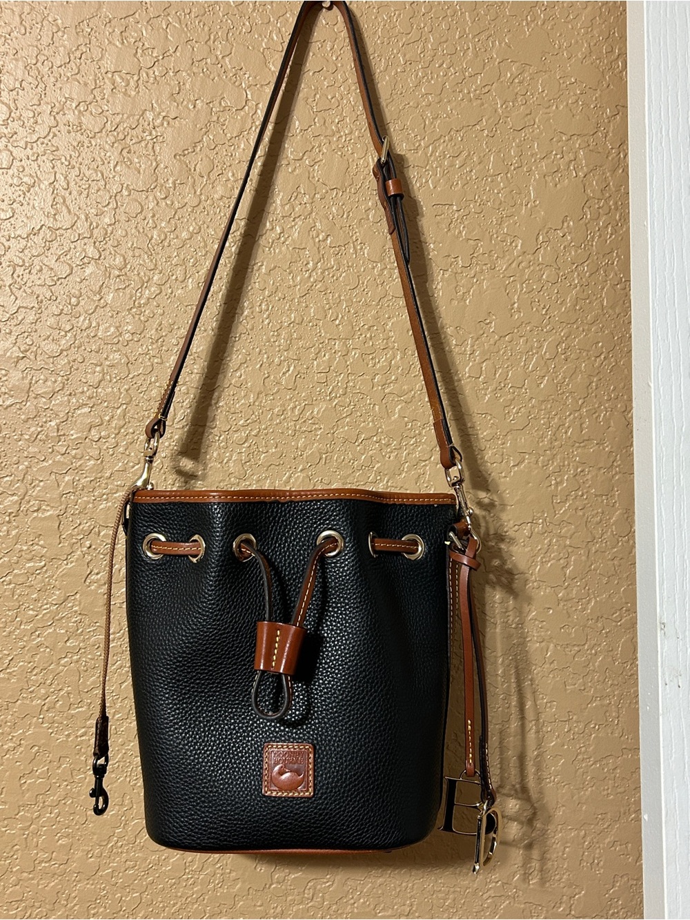Dooney & Bourke Black Pebbled Leather Drawstring Shoulder Bag with Brown Trim